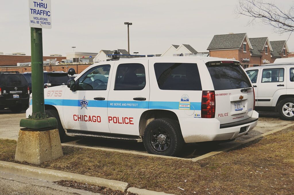 A white Chicago Police Department Chevrolet Tahoe parked in a lot.