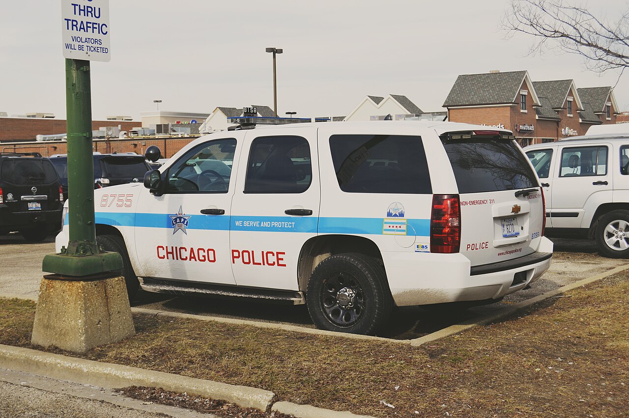 A white Chicago Police Department Chevrolet Tahoe parked in a lot.