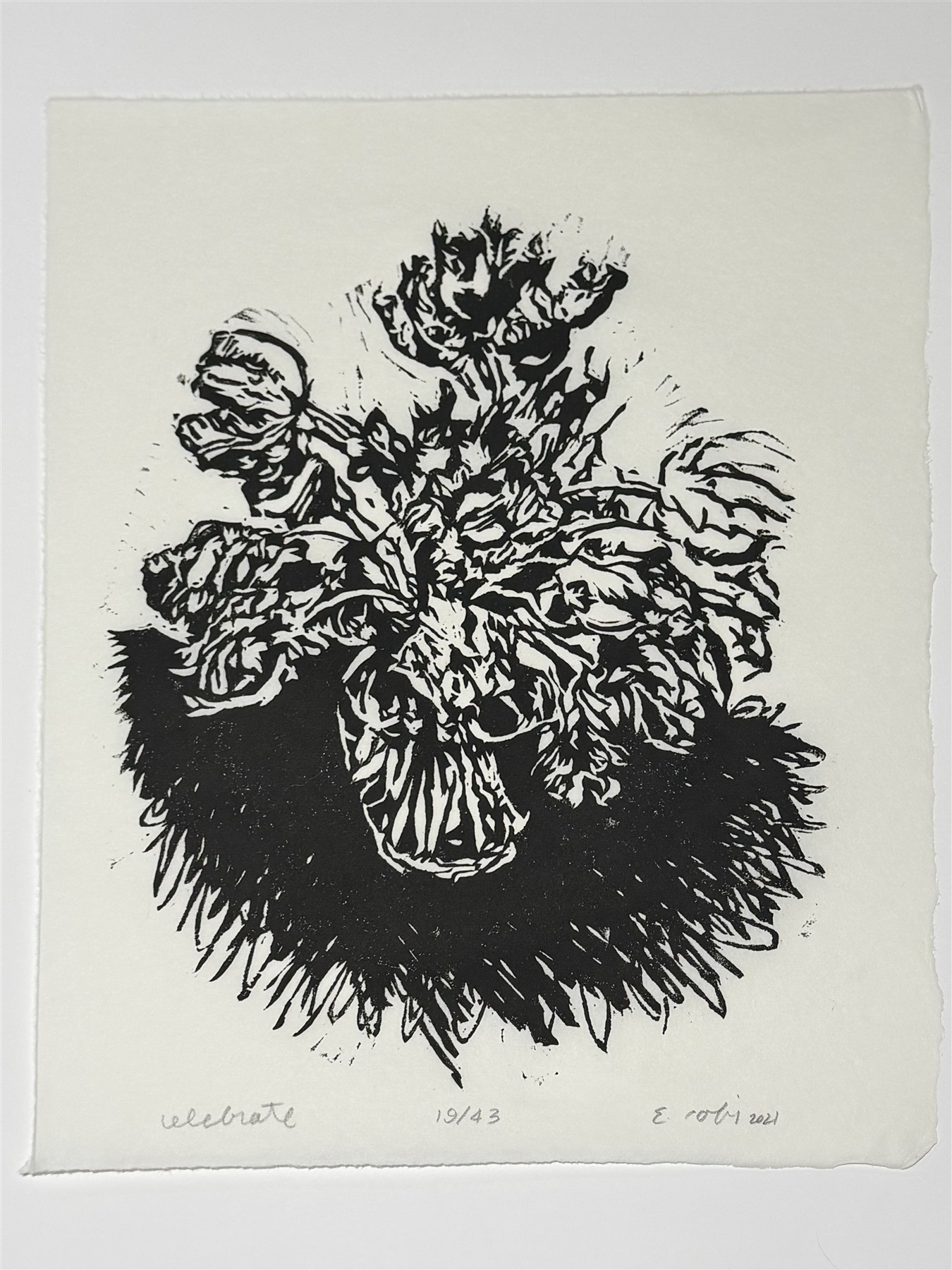 Black-and-white linocut of flowers in a vase, titled celebrate.