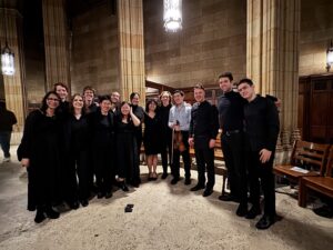 SOLACE singers with conductor Caspar Wein and composer and violin soloist Atticus Margulis-Ohnuma.