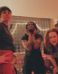The three members of BEASTII pose together in a tiled bathroom.
